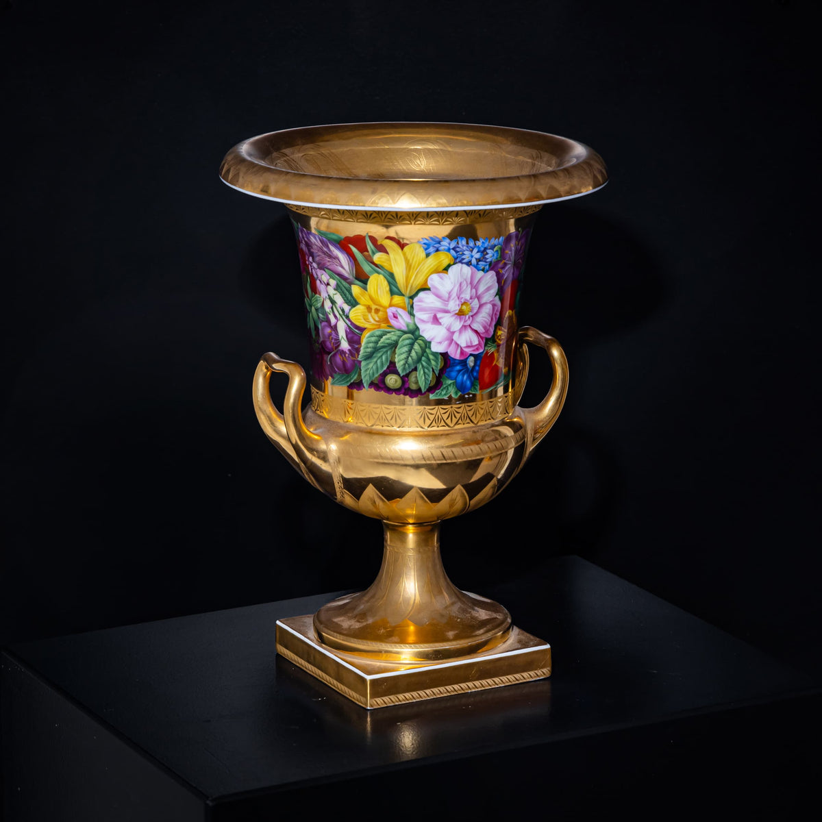Decorative urn with floral design on a black background
