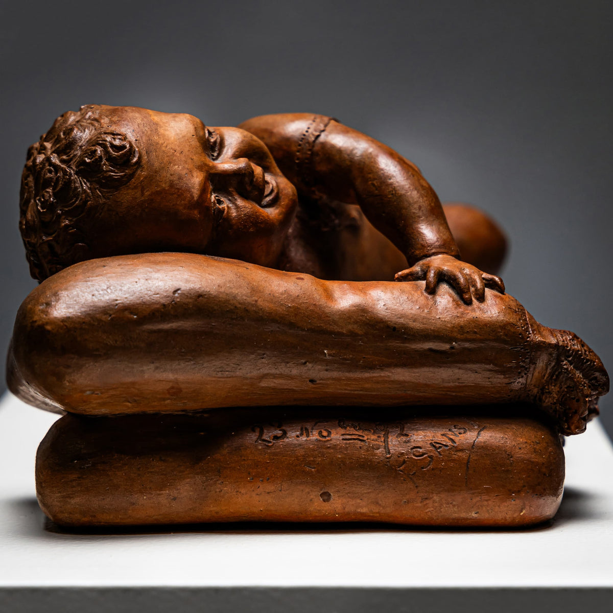 Reclining infant in terracotta, sign. F. Sans, probably Spain, Late 19th century