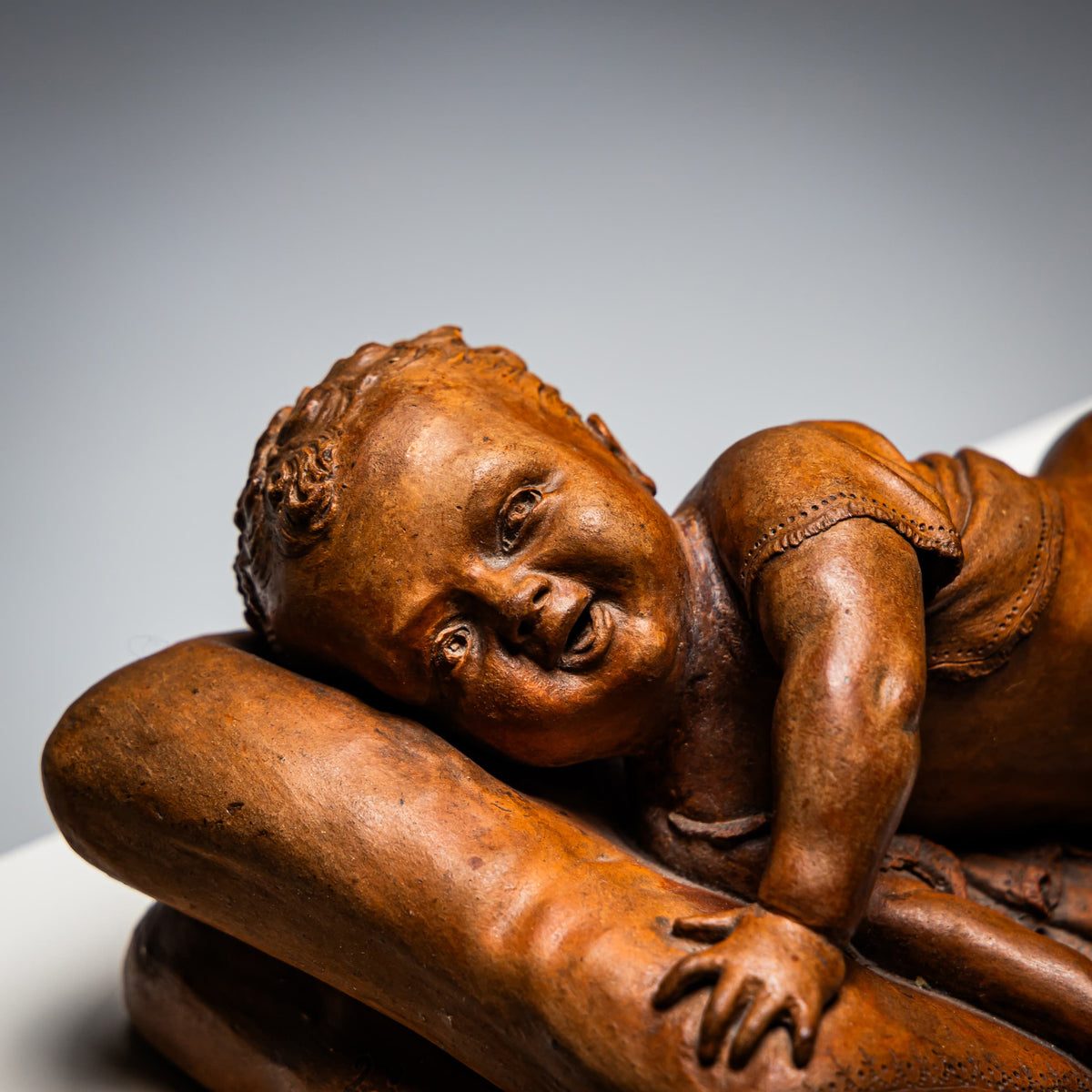 Reclining infant in terracotta, sign. F. Sans, probably Spain, Late 19th century