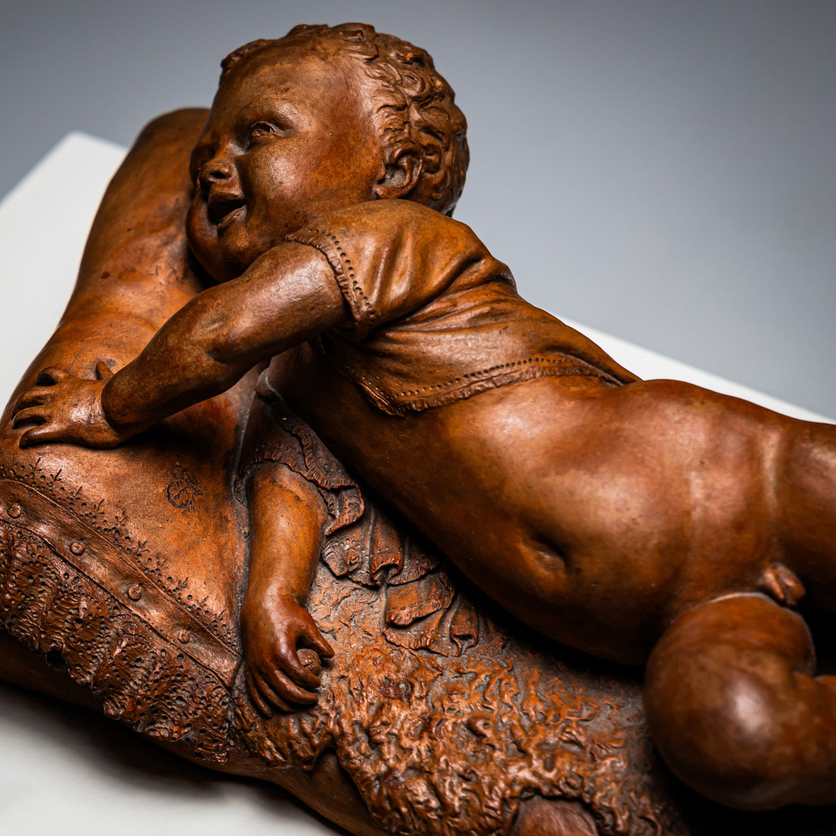 Reclining infant in terracotta, sign. F. Sans, probably Spain, Late 19th century